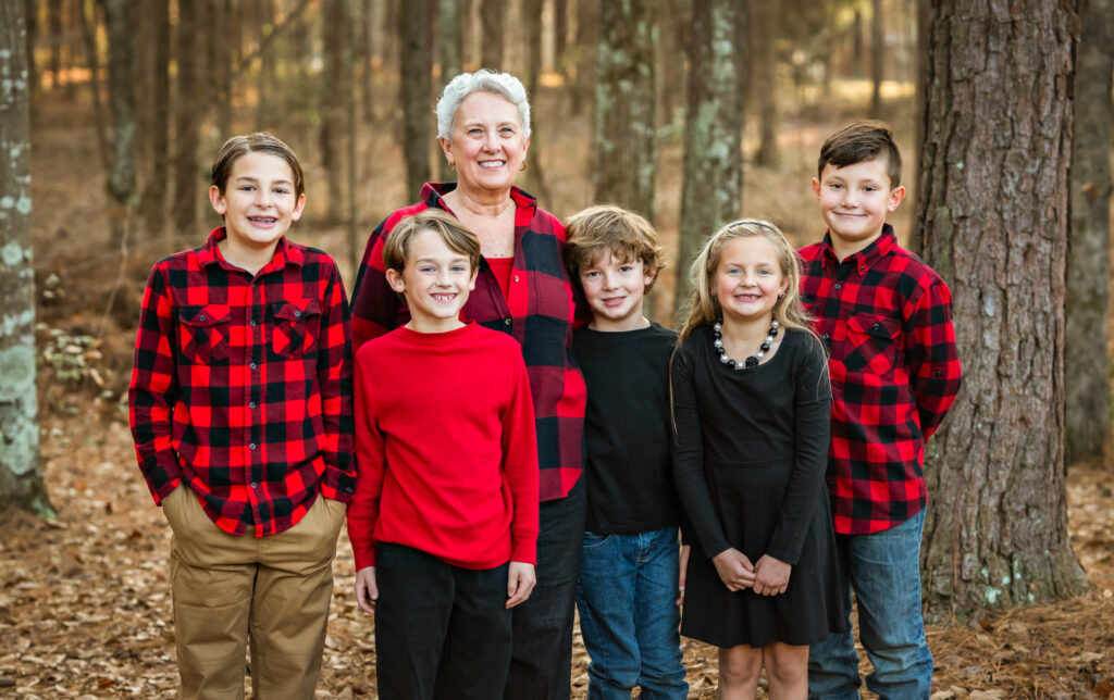 5 young cousins all stand beside their grandmother as they pose for the camera at their family photoshoot. 